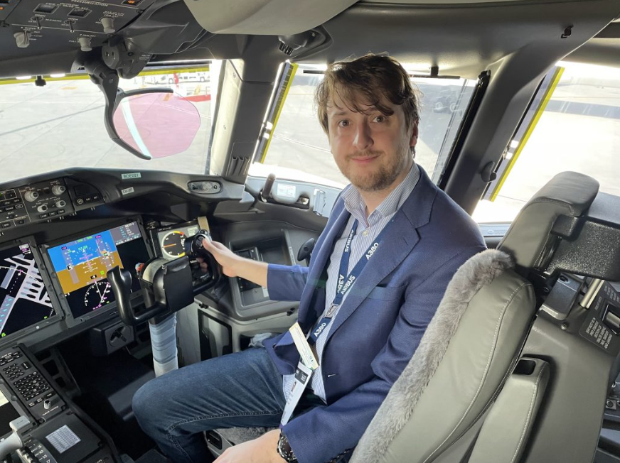 Simple Flying employee seated in plane